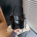 Fashionable black bucket bag with glossy wrinkled texture and drawstring closure - Black