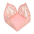 Macro view of pink pearlescent laser-cut hollow leaf design favor box for candies - Pink