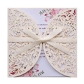Off-white laser-cut glitter wedding invitation with a silk bow and floral insert - Glitter Ivory