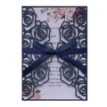 Detail of laser-cut rose floral invitation cover in navy blue with elegant satin bow - Magic Blue