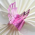 Detailed view of glossy pink angel wing napkin ring with intricate cutout patterns - 20cm / Nail Powder