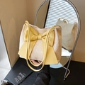 Fashionable lemon yellow straw bucket bag with large leather bow and dual straps - Yellow
