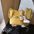 Yellow lychee texture bucket bag with adjustable strap and cute duck plush charm - With Charm / Yellow
