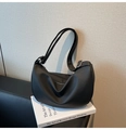Detailed macro view of black lychee grain leather underarm bag with silver buckle - Black