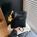 Black lychee texture bucket bag with a yellow duck pendant and adjustable strap - With Charm / Black
