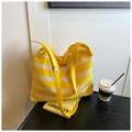 Detail of yellow and white striped woven tote bag with adjustable strap and horn toggle - Yellow
