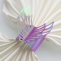 Close-up of rainbow iridescent laser-cut angel wing napkin ring on white fabric - 20cm / Rainbow Purple