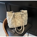 Quilted cream tote bag with silver chain strap and logo patch on a black chair - Off-white