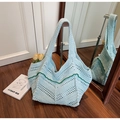 Macro view showing the intricate hollow crochet weave and green wave trim of the tote bag - Green
