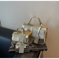 Detail of metallic gold handbags showing woven texture and shiny mirror finish - Gold Large