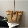 Bohemian straw woven tote bag with fringe trim and brown leather handles in beige - Khaki