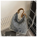 Washed blue denim hobo bag with embossed FASHION lettering and brown fabric strap - Retro Denim Blue