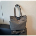 Detail of grey canvas tote bag with brown TAOCAITU logo, zipper pocket and fabric texture - Dark Brown