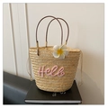 Straw tote bag with pink Hello text embroidery and a white floral accessory decoration - Pink