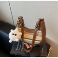 Detail of colorful woven shoulder bag with leather trim and plush monster charm - Brown
