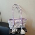 Lavender woven shoulder bag with geometric patterns and long silver tassel detail - Purple