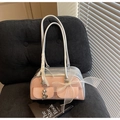 Detail of a pink saddle bag featuring a white mesh bow and a silver heart pendant - With Charm Style / Pink (With Heart Pendant)