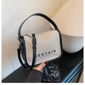 Detail of the vintage canvas crossbody bag with black leather trim and metal hardware - Beige