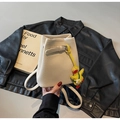 Off-white lychee texture bucket bag with yellow duck charm on black leather background - With Charm / Off White