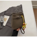 Lychee texture bucket bag in dark khaki with cute yellow duck charm and strap detail - With Charm / Gray