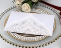Detail of laser-cut lace pattern on elegant wedding invitation card with floral decor - White