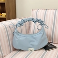 Light blue pleated dumpling bag with bow handle detail and soft croissant silhouette - Light Blue