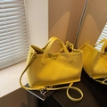 Chic bright yellow textured bucket bag with top handles and adjustable shoulder strap - Yellow