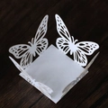 White laser-cut butterfly candy box for weddings and parties on dark wood background - White