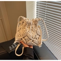 Detail of bohemian macrame woven bag featuring wood bead accents and fringe tassels - Off White