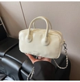 Detail view of cream mini bowling bag with leather texture and silver chain strap - White