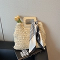 Beige woven straw tote with wooden handles and decorative striped scarf for beach vacation - Off White