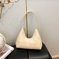 Close-up of beige hobo bag with crocodile embossed pattern and smooth zipper detail - Beige Apricot