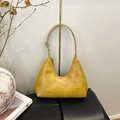 Close-up of yellow crocodile pattern shoulder bag with crescent moon shape design - Vintage Brown