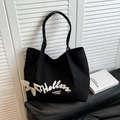 Große schwarze Canvas-Einkaufstasche mit Helloss-Aufdruck und weißem Blumenanhänger für Damen - Schwarz