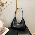 Detail of black crocodile pattern leather underarm bag with silver zipper and strap - Black