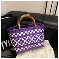 Detail of purple woven tote with natural bamboo handles and white geometric diamond pattern - Purple