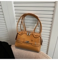 Detailed side view of caramel shoulder bag featuring silver buckle and belt decoration - Brown