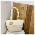 Detail of two-tone woven tote bag with twisted rope handles and purple butterfly charm - White