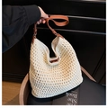 Detail of hand-woven straw tote bag with brown leather straps for summer beach vacation - White