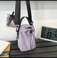 Detail der helllila Nylon-Beuteltasche mit verstellbarem schwarzen Schultergurt - Lila