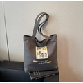 Detail of the moon and sixpence print on gray canvas tote bag with shoulder straps - Black