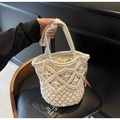 Detail of white hollow woven bucket bag with beige drawstring lining and geometric patterns - Off-white