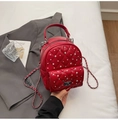 Detail of red quilted mini backpack with rhinestone embellishments and silver chain - Burgundy