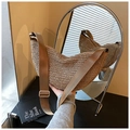 Detail of hand-held khaki woven straw moon bag with an adjustable wide brown shoulder strap - Khaki
