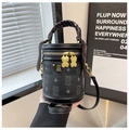 Detail of black cylinder bag with teddy bear monogram and silk scarf wrapped handle - Black