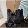 Detail of vintage blue denim tote bag with functional pockets and contrast stitching - Black