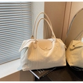 Chic beige large tote bag featuring pleated fabric texture and smooth leather handles - White