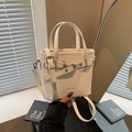White lychee grain bucket bag with silver metal buckles and decorative strap - Off-white