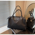 Casual black tote bag with pleated fabric texture and leather handles in a side view - Black