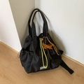 Detail of black nylon drawstring bag featuring yellow cords and a fashion brand label - Black (with Pendant)